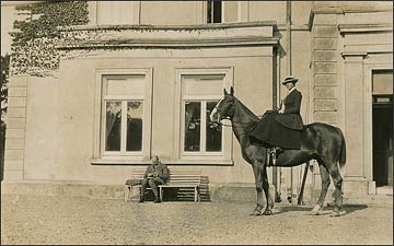 On horseback in front of the house